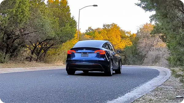 Rear of Model Y Driving